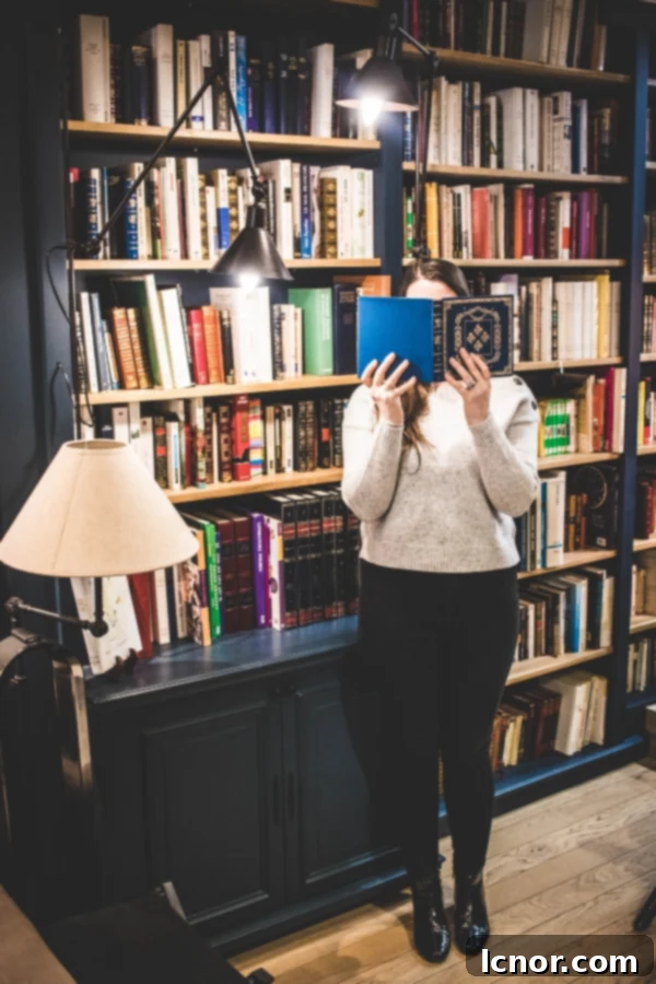 10 Paris Insider Spots: Experience the City Like a Local 6 girl standing in front of a book case with a book in front of her face at Paris Boutik Paris