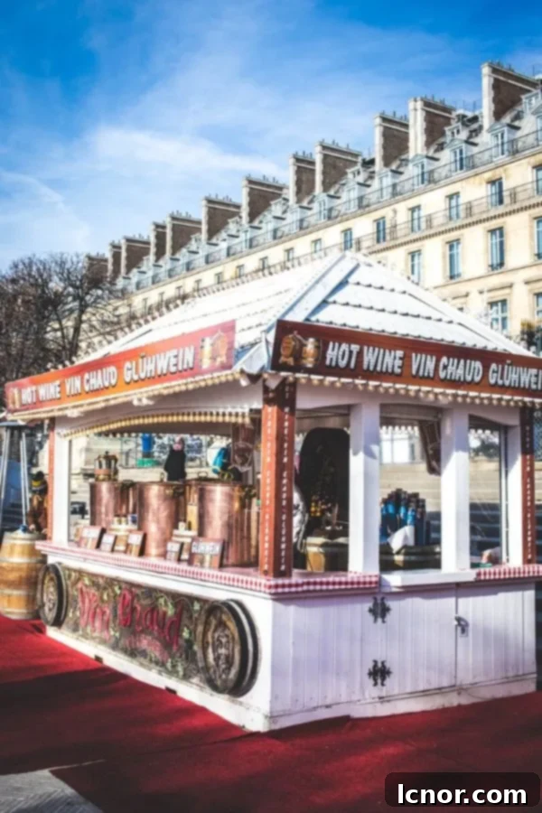 Festive chalet at the Paris Christmas market in the Tuileries Gardens, bustling with visitors and decorated for the holidays.