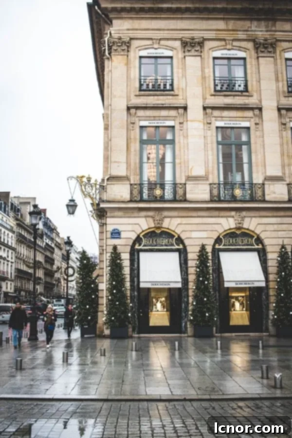 The Place Vendome in Paris illuminated with elegant Christmas decorations and trees.