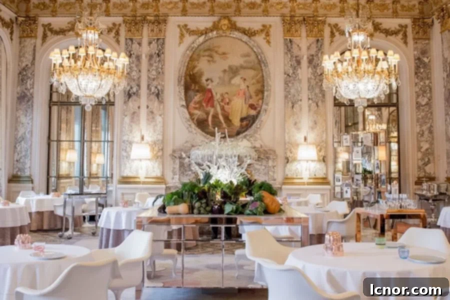 The opulent and lavish dining room at Le Meurice Alain Ducasse in Paris, set for a grand dinner.