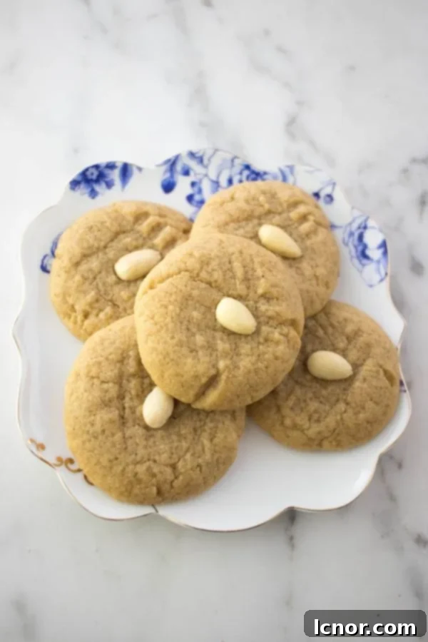 A plate of freshly baked almond butter cookies, perfectly golden and ready to be enjoyed.
