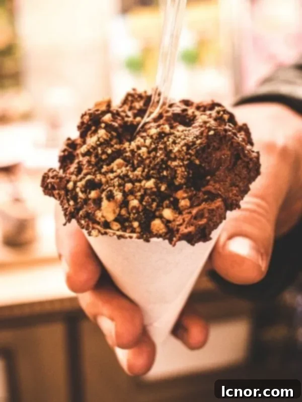 A scoop of rich chocolate mousse served in a delicate cone, a heavenly Parisian treat.