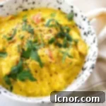 Close-up of a vibrant Chicken Karahi, an Indian chicken curry, served in a stylish white and black bowl