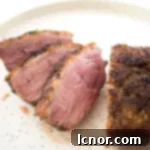 Sliced Magret de Canard on a white speckled plate