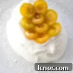 Schaum Torte topped with yellow mirabelle prunes