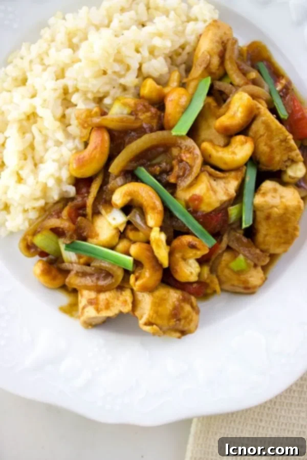 Siam Cashew Chicken Stir-Fry 3 close up of Thai chicken with cashews and white rice on a white plate