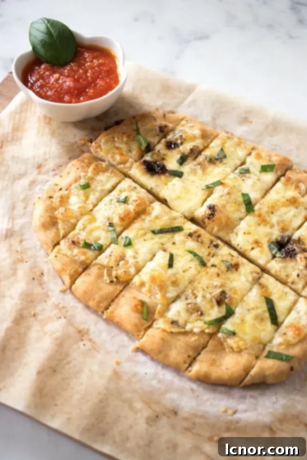 sliced Italian dunkers on a wooden board with a red marinara dipping sauce
