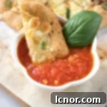 dipping Italian dunkers in marinara sauce
