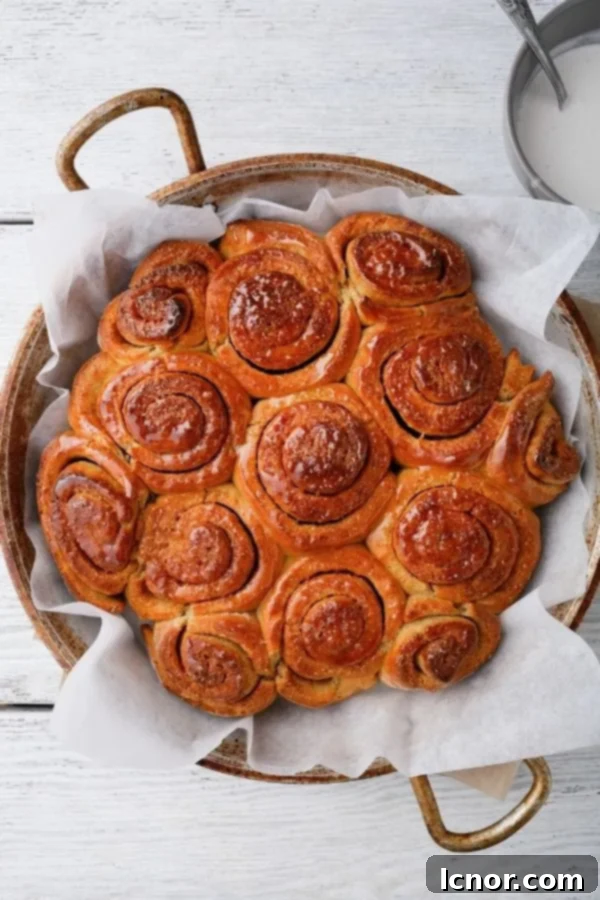 Close-up of freshly baked sourdough discard cinnamon buns with glaze.