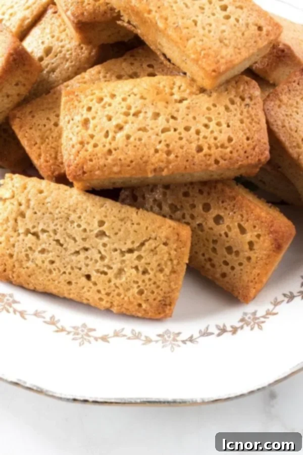 A stack of perfectly baked Brown Butter Financiers, golden brown and inviting.