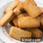 French brown butter financiers stacked on a vintage plate, ready to be served