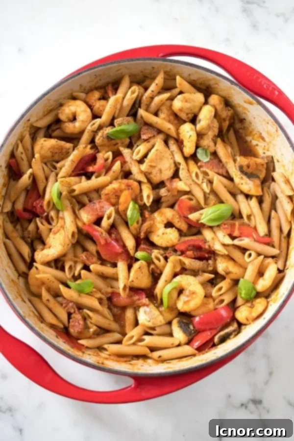 overhead photo of cajun chicken and shrimp pasta in a pan