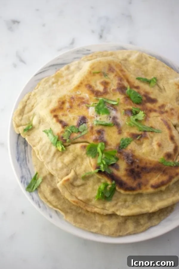 Sourdough Naan on a plate with fresh cilantro.