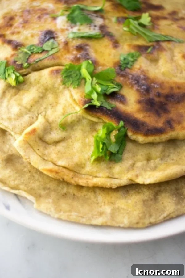 close up of Sourdough Naan on a plate, ready to be picked up.