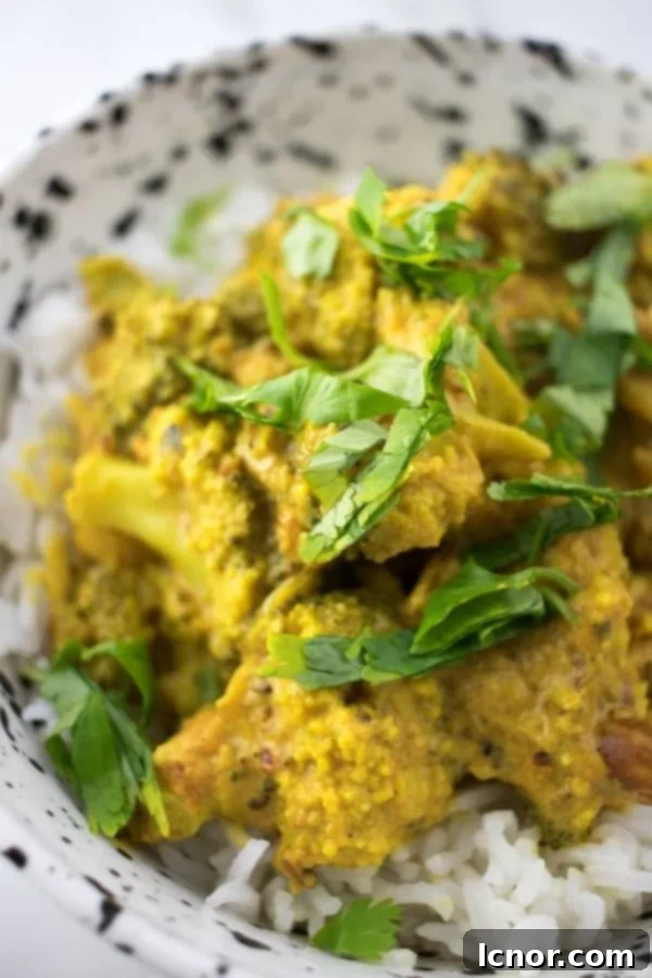 overhead view of Indian broccoli curry in a white and black speckled bowl