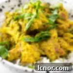 Indian broccoli curry topped with fresh cilantro in a white and black speckled bowl