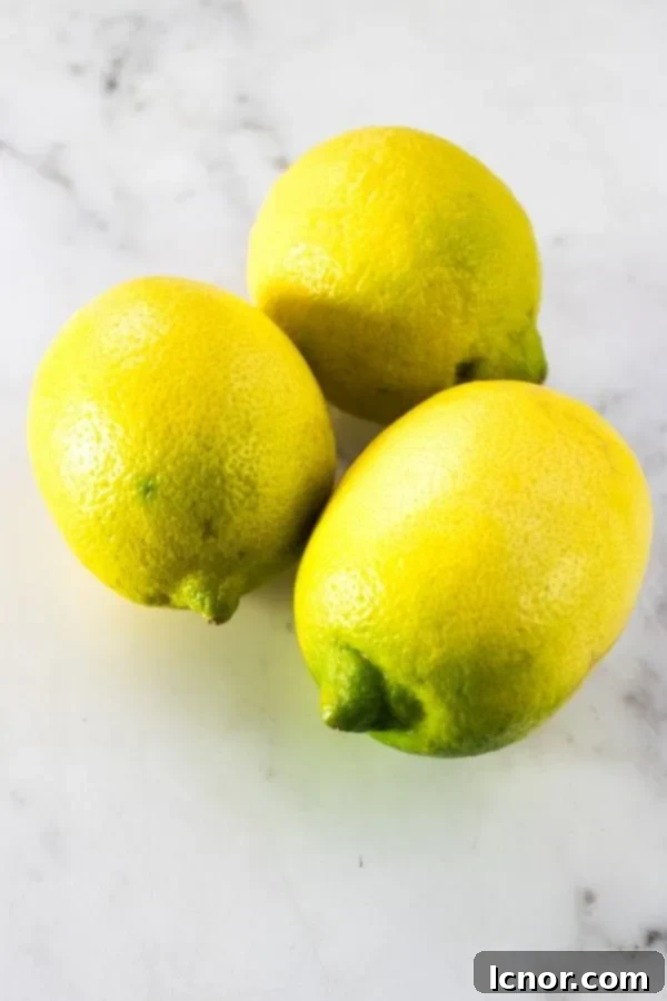 Close-up of vibrant, fresh lemons, ready to be sliced and used as a garnish for cocktails like the Hugo Spritz