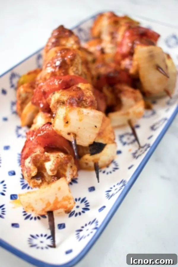 Delicious oven baked chicken kabobs served on a blue and white ceramic tray, perfect for an easy weeknight dinner