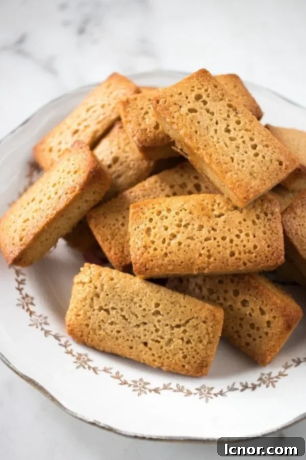 Golden-brown Brown Butter Financiers, small almond cakes, elegantly presented.