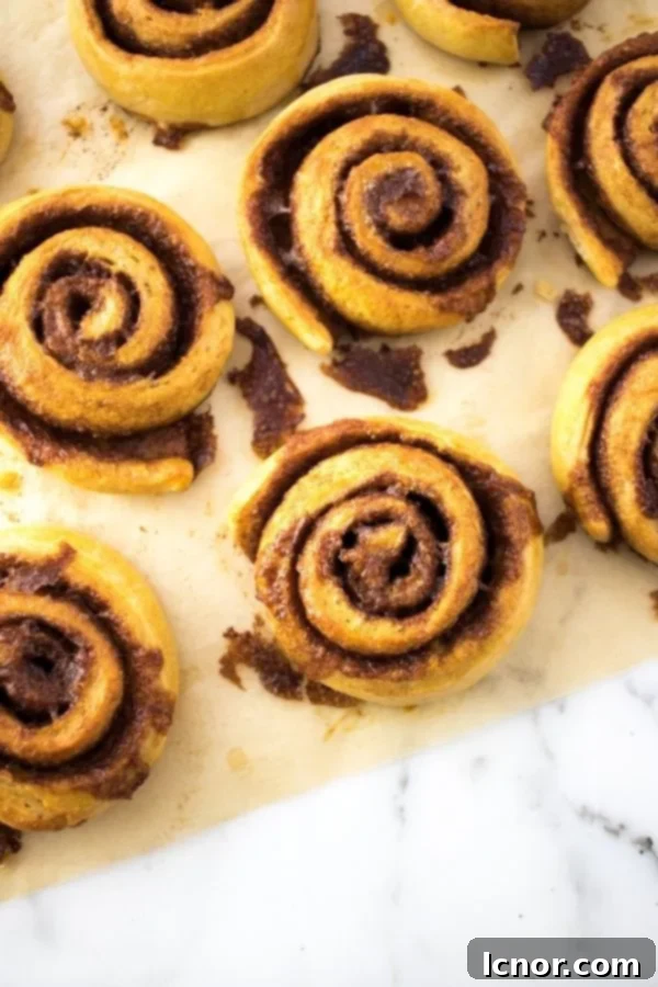Kanelsnegle Danish cinnamon rolls on a baking sheet, golden brown and perfectly swirled