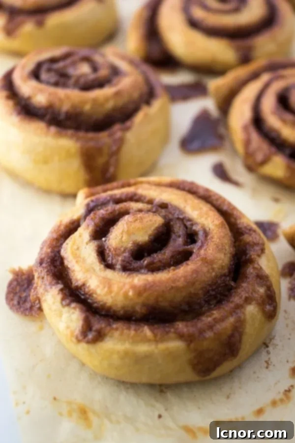 Pile of warm, glazed Kanelsnegle Danish cinnamon rolls, invitingly soft