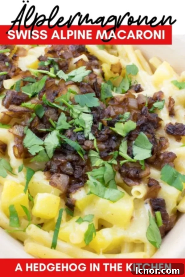 A Pinterest-friendly image of Älplermagronen (Swiss Alpine Macaroni) in a red baking dish, garnished with parsley and with a small bowl of applesauce to the side, encouraging users to save the recipe.