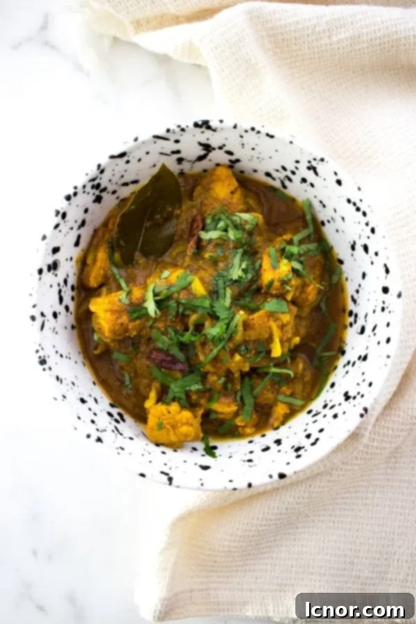 Nepali Chicken Curry in a white and black bowl