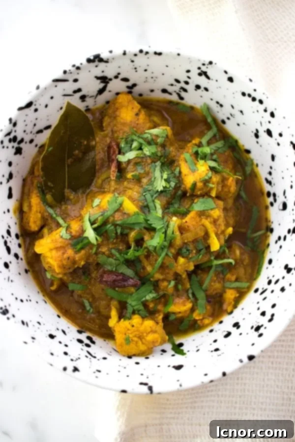 Nepali Chicken Tarkari in a white and black bowl