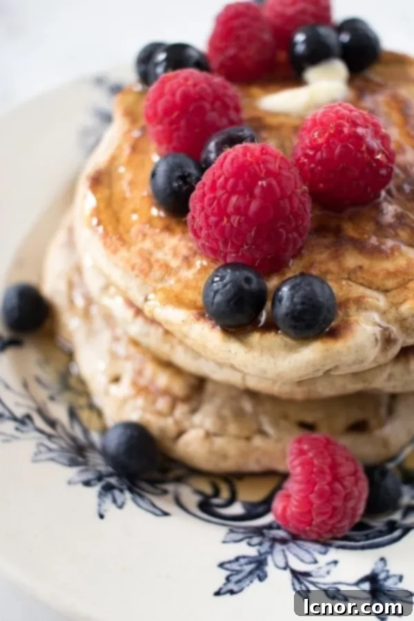 sourdough pancakes topped with raspberries and blueberries