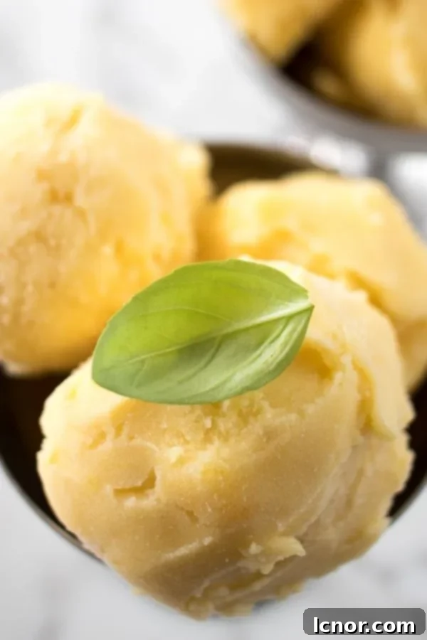 Scoops of Filipino Mango Ice Cream served in a bowl, highlighting its creamy texture.