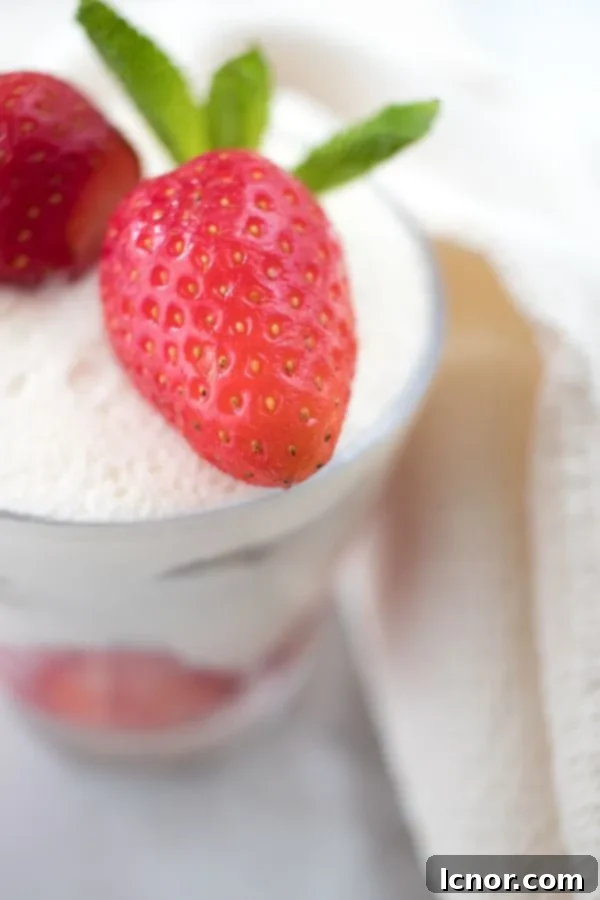 close up of strawberry tiramisu with a cream background, showing the texture