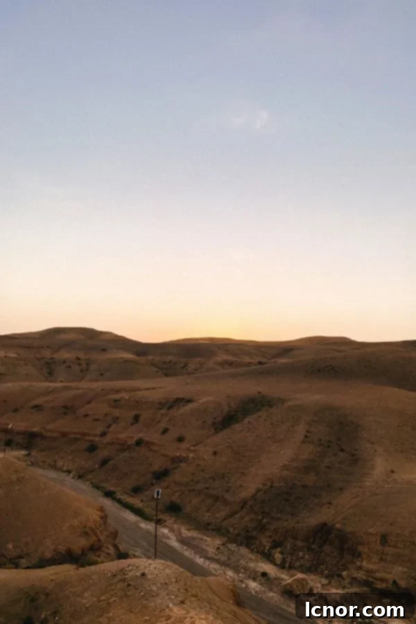 the sun rising over the Agafay Desert in Morocco at the Agafay Luxury Camp