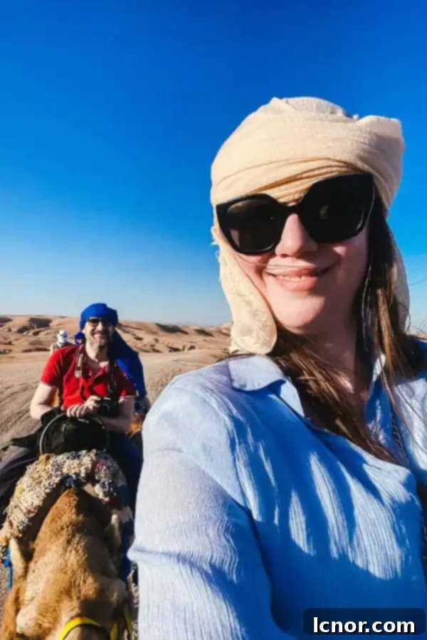Man and woman riding camels in the Agafay Desert at the Agafay Luxury Camp, one of the Agafay Desert Luxury Camps in Morocco