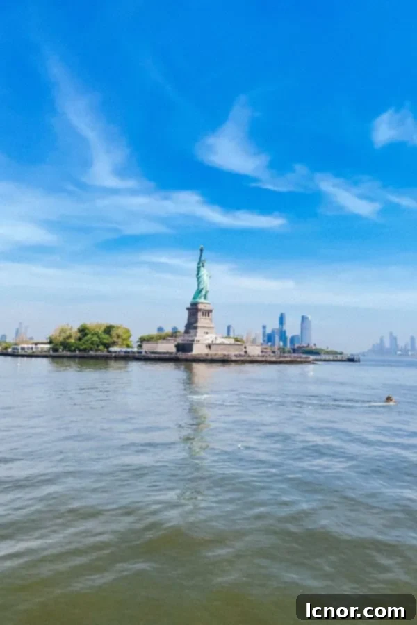 View of the Statue of Liberty from the shore, symbolizing freedom and welcoming.