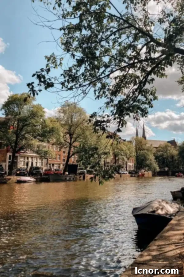 Beautiful Amsterdam canals lined with charming buildings, perfect for a leisurely evening stroll