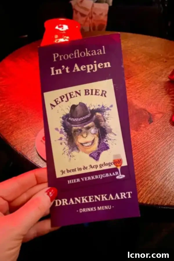 Drinks menu displayed on a chalkboard at In't Aepjen, the Monkey Bar Amsterdam, showing a selection of beers and other beverages.