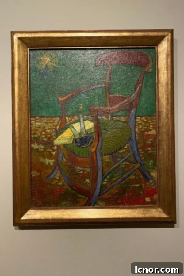 Gauguin's Chair, 1888, a symbolic still life by Van Gogh, featuring a chair with a lit candle and books, at the Van Gogh Museum.