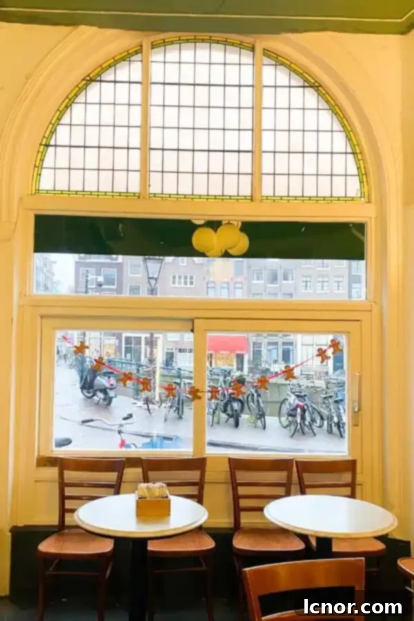 The charming interior of Lanskroon Bakery Amsterdam, showcasing shelves of pastries and a cozy tearoom ambiance.