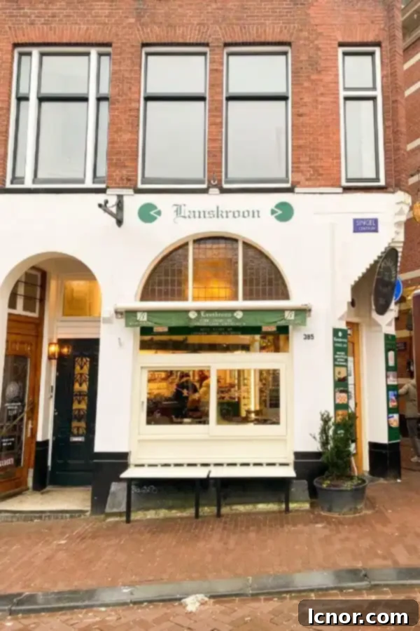 The charming exterior of Lanskroon Bakery Amsterdam, with its traditional facade and inviting atmosphere by the canal.