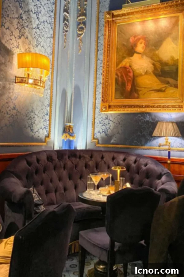 Blaue Bar, Vienna, Austria, blue velvet couch, painting and lamps, romantic evening bar
