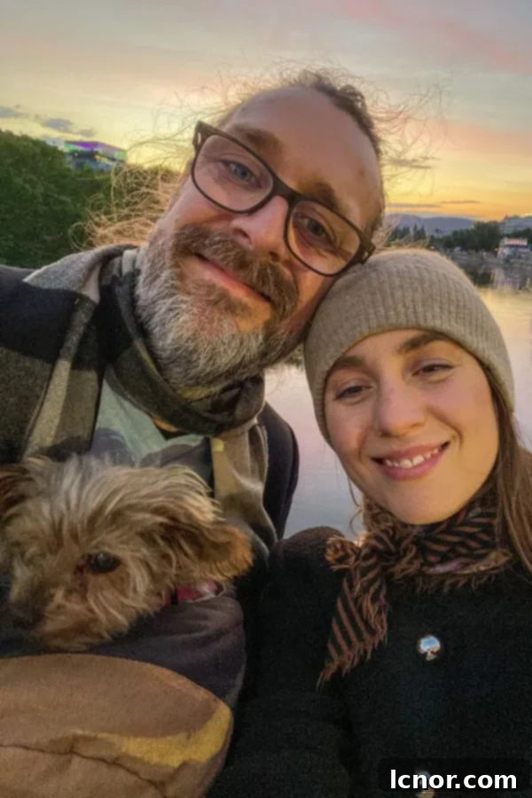 Man, woman and dog on the Danube Canal, Vienna, on a romantic walk at sunset