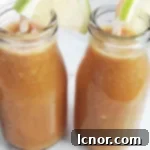 Vibrant Mango Banana Carrot Smoothie in a glass jar.