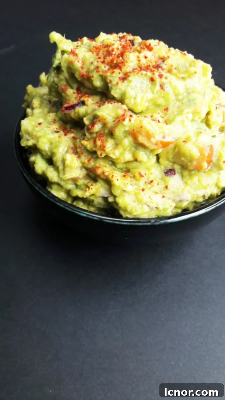 Freshly made sailboat guacamole in a bowl, set against a blurred background of a sailboat deck and the sea, emphasizing a vibrant, healthy snack for sailors.