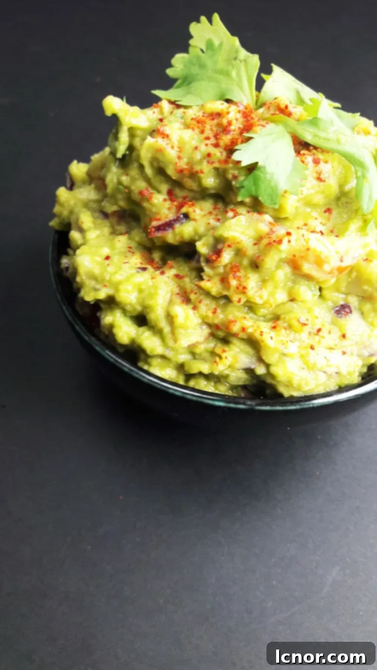 A bowl of sailboat guacamole with tortilla chips, ready to be served on a boat, highlighting its role as an easy and delicious snack for sailors.