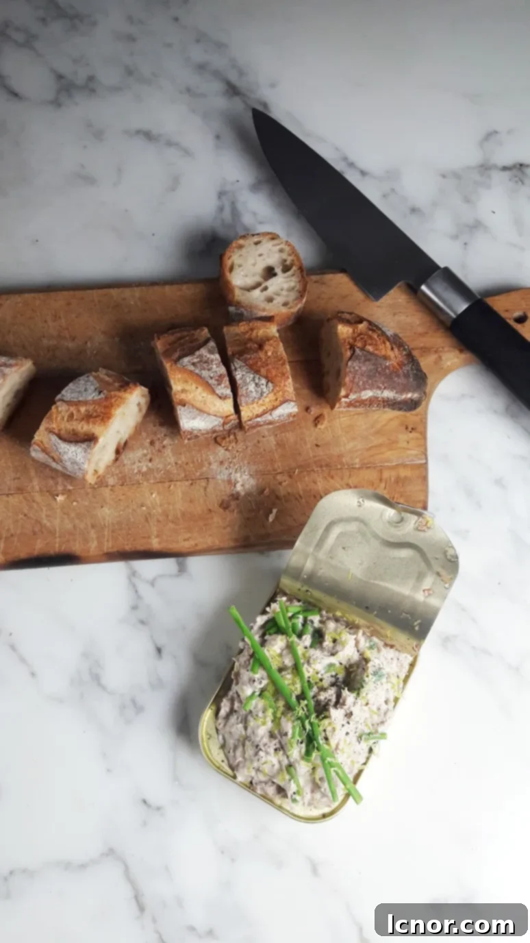 sardine rillettes in a bowl next to a sailing view