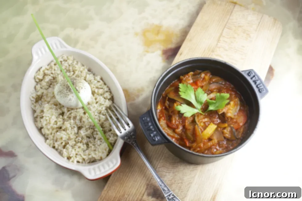 French ratatouille recipe in a Staub cast iron pot and brown rice topped with a poached egg