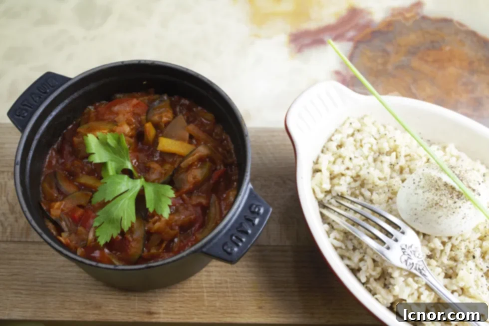 French ratatouille recipe in a Staub cast iron pot and brown rice topped with a poached egg
