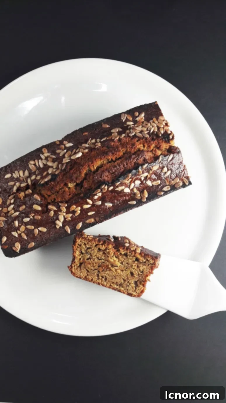 Deliciously moist zucchini cake topped with sunflower seeds, ready for breakfast or snack