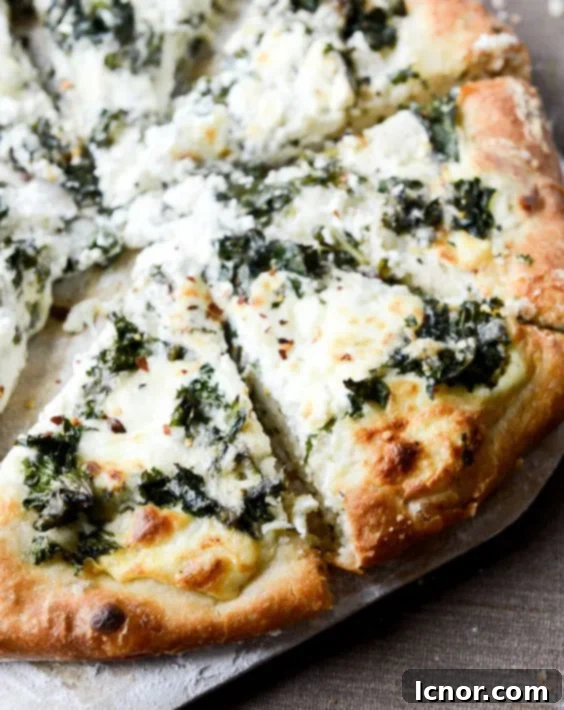 Delicious homemade pizza topped with marinated kale and creamy whipped ricotta cheese, a healthy and inspiring recipe idea.