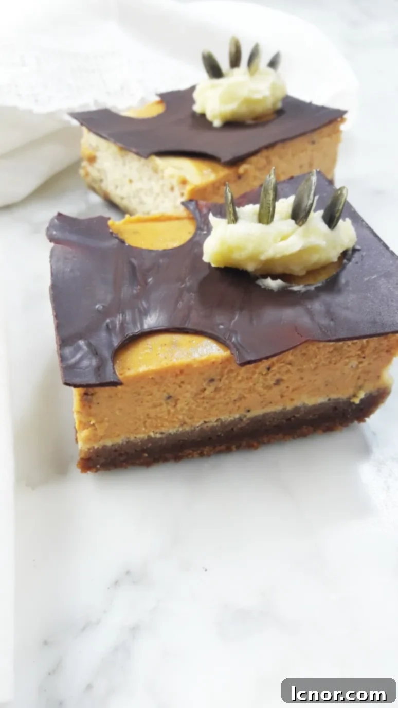 Beautifully arranged homemade pumpkin cheesecake bars with a rustic, autumnal feel, perfect for a cozy dessert table.